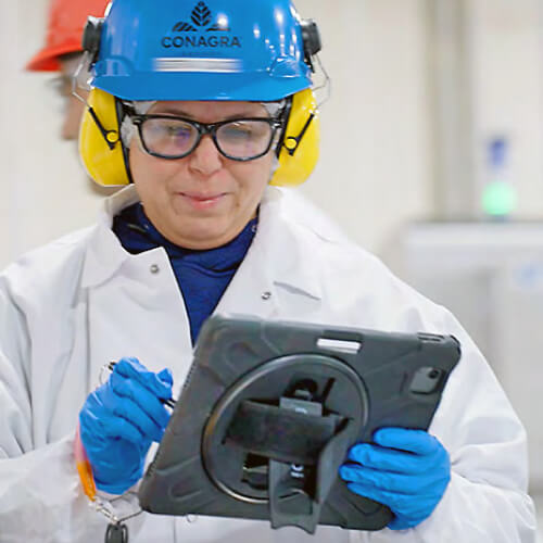 Worker in gear writing notes