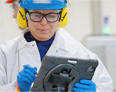 Worker in gear writing notes