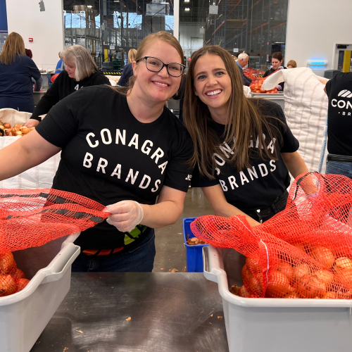 Employees holding produce
